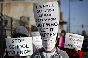 Their faces covered by signs, Asian students march to a school board meeting in Philadelphia last week.