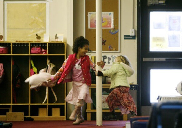 First-grader Jenneth McNees, left, and kindergartner Julia Swerdloff play outside a classroom. The charter school shares its building with a gymnastics club. "One thing that's really problematic for us is chalk dust, because gymnasts dust their hands," said Anser school business manager Suzanne Burton. "Our students' cubbies get covered with the dust."
