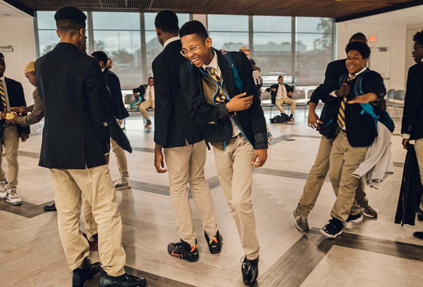 Ron Brown College Preparatory High School students greet each other during the morning circle in Washington. The all-male school is designed specifically to meet the needs of young black men in the nation’s capital.