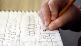 A 2nd grade pupil put pencil to paper to work through a math set.