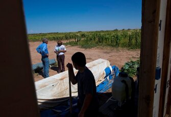A STAR School student takes a break from harvesting at the farm.