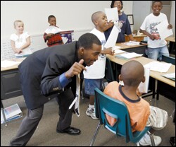 An enthusiastic motivator, Hayward Jean raps in the ear of Daiquan Lee during free time in Jean's 3rd grade class. Lee decided to read as his classmates learned a new song called "Knowledge is Power."