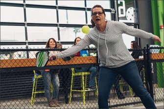 Teacher Beth Defebaugh plays pickle ball at Chicken and Pickle in Wichita, Kansas, during a teacher field trip meant to show teachers real world applications for learning.