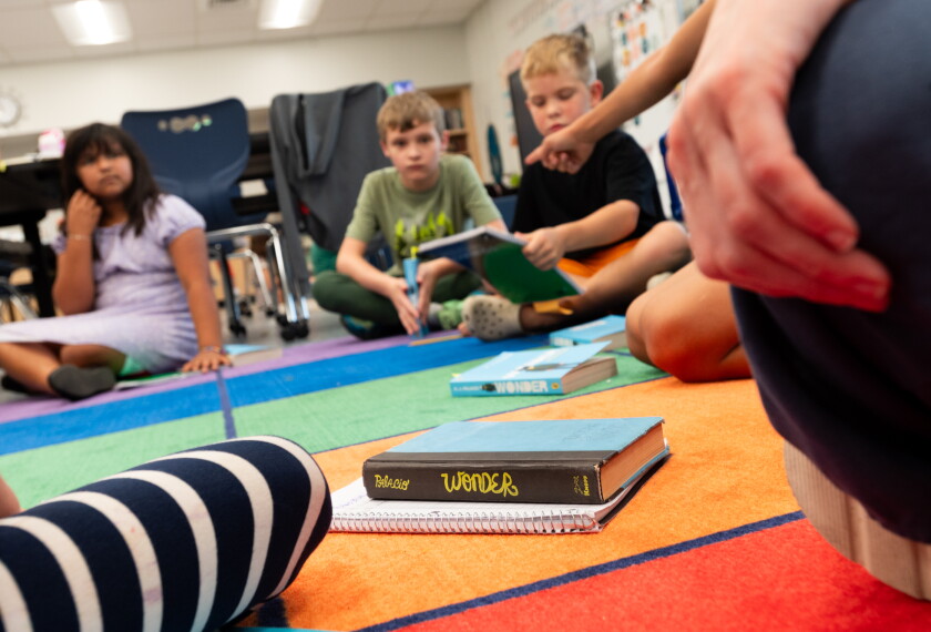 Natalia Gutierrez, age 10 (5th grade), Garrett Christian, age 10 (5th grade), William Robinson, age 8 (3rd grade), wait to begin reading time in the afternoon at Creative Minds School in Wichita, Kansas on September 15, 2026.
