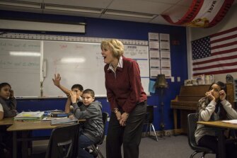 Julie Bowline enjoys a lighter moment with students while visiting a math class at The International School at Thornton Middle School.