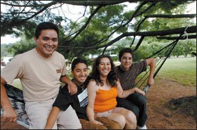 Amin Ruiz, 17, second from left, participated in a migrant-student leadership program at West Chester University of Pennsylvania. With Amin are his brother, Alejandro Ruiz, 15, far right, their mother, Alejandra Hernandez, and her partner, Juan Lopez, left, in the backyard of their home.