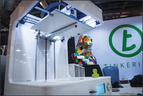 A bust of Benjamin Franklin sits in a 3-D scanner and printer exhibited by Tinkerine.