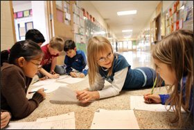 Third grader Olivia Swenson, center, works with classmates at South St. Paul’s Lincoln Center Elementary School on an assignment for an IB Primary Years class.