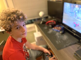Jack Fitzgerald, 14, an 8th grader at Hogg Middle School in Houston, Texas, plays Rocket League at home this week when school was cancelled because of icy weather and widespread power outages. Jack's family had to stay with friends briefly when their home lost power and indoor temperatures plunged.