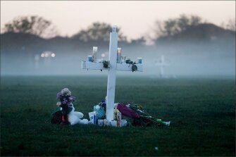An early morning fog rises where 17 memorial crosses were placed in memory of the deceased students and faculty from the shooting at Marjory Stoneman Douglas High School.
