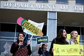 A group of protesters gather outside the U.S. Department of Education in Washington before Betsy DeVos, recently confirmed as Secretary of Education, was scheduled to speak to the department staff on Feb. 8.