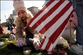 Ashley Mesman, 8, places a candle over a Boy Scout kerchief as people gathered to honor President Gerald R. Ford near the Gerald R. Ford Presidential Museum in Grand Rapids, Mich., on Jan. 2.