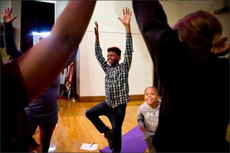 Sixth grader Jamel Dandridge, 12, and Lele Cayard, 7, do yoga during the Higher Achievement after-school program at Binford Middle School in Richmond, Va. The programs typically run until 7 p.m. and include a wide range of academic, social-emotional, and physical activities.