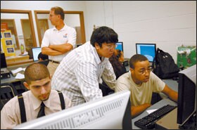 Senior Andrew Kim, second from right, works with Richard Sutton during their class in engineering design and development at Wheaton High’s engineering academy. Mr. Kim, who started out with poor grades, plans to study mechanical engineering in college next year.
