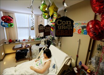 Harrison Bowe, a senior at Bellair High School in Houston, waits in his hospital room at Houston Methodist Hospital, where his parents and school representatives will hold a graduation ceremony for him. He is still recovering from surgery from complications from a rare bladder birth defect.