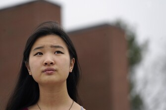 High school student Grace Hu, 16, of Sharon, Mass., stands for a photograph near Sharon High School on April 11, 2021. Hu, who plans to to go back to in-person classes in April, helped organize a rally in Boston in early April against anti-Asian hate, but said she's not concerned about facing vitriol when her school reopens fully. The district, located about 27 miles south of Boston, has a sizable Asian student population and has felt generally safe and welcoming to her.