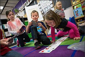 Owen O'Brien, center, and Ava Ford, right, play a number-matching game during choice time at Jefferson Elementary School. Children get some time to choose their play activities.