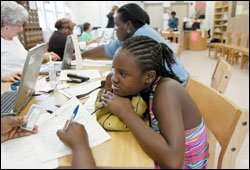 Mariah Lyons, 10, waits to be registered at Clark High School, one of many public schools in New Orleans that are being run directly by the state of Louisiana under an unconventional arrangement taking place in the city.