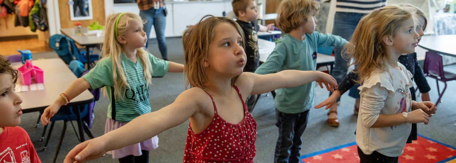 Beatrice Hesseltine, center, and her classmates in Alyssa Saunders’ kindergarten class take a movement break during class at Vergennes Union Elementary School in Vergennes, Vt., on Nov. 19, 2024.
