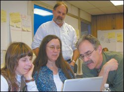 Mentors Joan Walswer, left, Susan Hubbard, and Rick Frederic meet in Fairbanks with outreach coordinator Tom Howe, right, from the New Teacher Center.