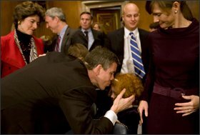 Secretary of Education-designate Arne Duncan kisses his daughter Claire following the committee hearing.