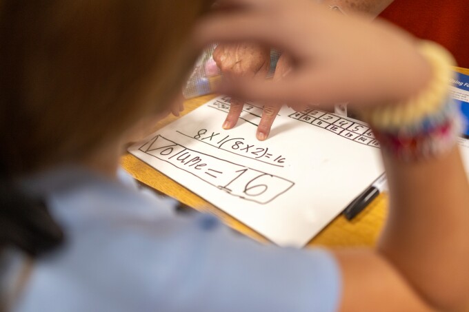 Casey Dupuis points to class work for a one of her 5th graders during a math class at Lafargue Elementary School in Effie, Louisiana, on Friday, August 22. The state has implemented new professional development requirements for math teachers in grades 4-8 to help improve student achievement and address learning gaps.