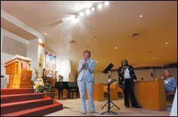 Robin Jarvis, the acting superintendent of the state-run Recovery School District, addresses residents at Mary Queen of Vietnam Church in New Orleans last month.