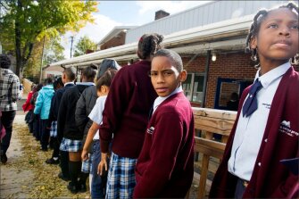 Brian Taylor, front left, and Season Williams, right, both 3rd graders, line up at Memphis College Prep, a charter school in Memphis, Tenn. Memphis, like many other communities, is undergoing profound changes in the structure and administration of its schools. In addition to merging with the neighboring Shelby County school system, Memphis includes a mix of regular public schools, state-run schools, and charter schools.
