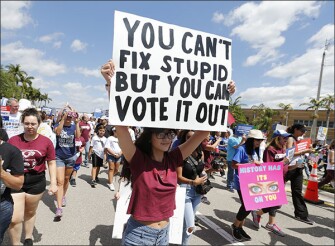 Demonstrators march to Marjory Stoneman Douglas High School after a "March for Our Lives" rally in Parkland, Fla. Thousands of people filled a park near the school, site of the Feb. 14 shooting that killed 17 people.