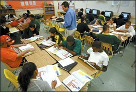 Teacher Mario Olaciregui works with pupils in a Reading XL class, which focuses on interactive lessons and small-group work. Students are assigned to reading classes based on their state-test scores.