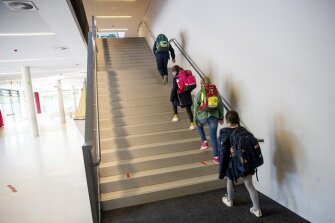 Students of a 4th grade walk at a distance on stairs to their classrooms in the Goldbeck Schoo in Hamburg, Germany, Monday, May 4, 2020. On Monday, lessons began again for more classes at the Hamburg schools, and the fourth graders returned to the primary schools.