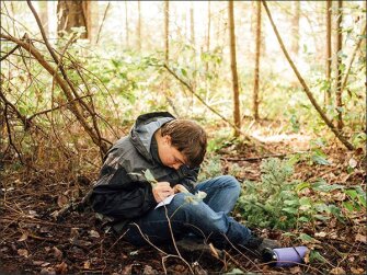 Sophomore Ethan Haller sketches a leaf during an Outdoor Education class at the Science and Math Institute in Tacoma, Wash.