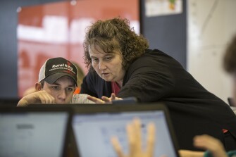 Math instructor Jenna Gray works with sophomore Isaac Logsdon on an Algebra 2 problem.