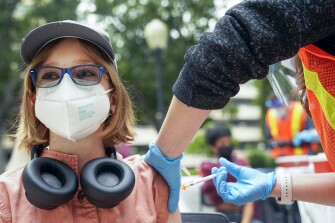 Gigi Morgan Clark, 12, gets a shot of the Pfizer COVID-19 vaccine at the First Baptist Church of Pasadena, Friday, May 14, 2021, in Pasadena, Calif.