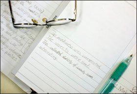 Students write about their observations in field journals after viewing insects under microscopes during an afternoon in the lab on the NatureBridge campus in Sausalito.