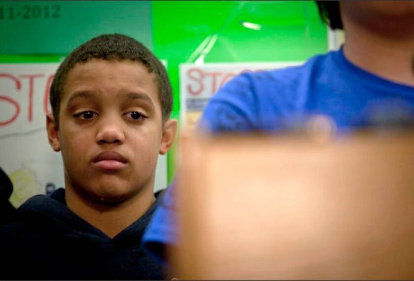 Damien McGee-Backes, 15, a plaintiff in a bullying lawsuit settled last week with the Anoka-Hennepin, Minn., district, attends a news conference at district headquarters. The school board agreed to a long list of measures to help address harassment based on perceptions about students' sexual orientation.