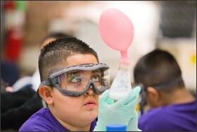Student Javier Muniz, 10, of Gallistel Academy examines a baking soda and vinegar experiment during a recent visit to the museum.