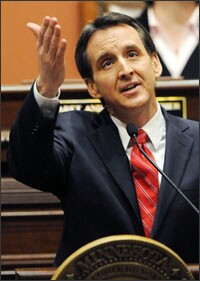 Minnesota Gov. Tim Pawlenty acknowledges a military family in the Minnesota House balcony as he delivers his last State of the State address at the Capitol in St. Paul this month.