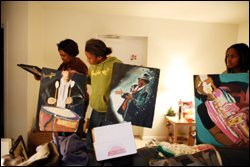 Schondra Sweeney, left, examines paintings from her home studio in Waveland, Miss., with daughter Holly, center, at their Arlington, Va., apartment. Sweeney's older daughter, Daniella, right, has continued to live in their home state since Hurricane Katrina seperated the family.