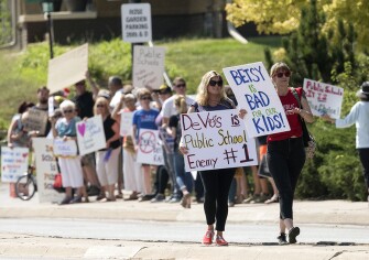 Protesters decry Devos’ support of charter schools and vouchers, marching to the Lincoln Children’s Zoo in Lincoln, Neb., as DeVos visited the Lincoln school system’s Science Focus Program/Zoo School.