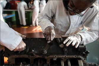 Kwamel Robinson cleans an airplane part during his aviation cleaning and corrosion class at Aviation High School.