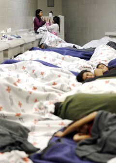 Two detainees play as others sleep in a holding cell at a U.S. Customs and Border Protection processing facility. Boys and girls are separated, but the very young stay with their mothers.