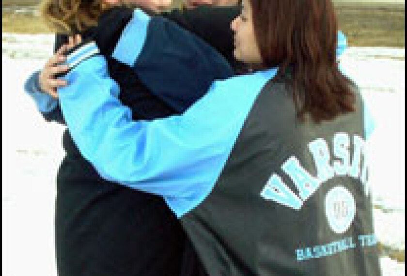 Red Lake High School students, from left, Sondra Hegstrom, Marla Hegstrom, and Ashley Morrison weep together following a deadly shooting rampage, Monday, March 21, 2005, at their school in Red Lake, Minn.