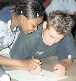 Students share a marker to draw their dream house during a workshop at H.F. Verwoerd High School.