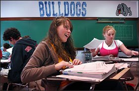 Portland High School senior Jenny Richard, center, and fellow senior Jess Dolan, right, take an AP Statistics class.