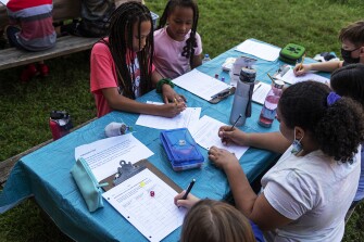 Lyric Monroe and Bobbi Johnson (top) and Jennifer Girgis (bottom right) participate in a math lesson during class at Centreville Elementary School in Centreville, Va., on Sept. 7, 2021.