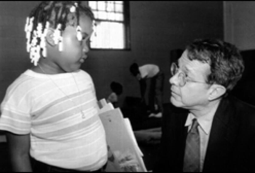 Jonathan Kozol talks with a student at St. Ann's Church in 1994, while researching a book on New york City's South Bronx.