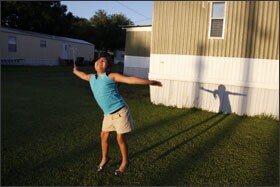Seven-year-old Ruby Pacheco plays outside her trailer home in Foley, Ala. Ruby is a 2nd grader at Foley Elementary School, where she tested out of the English-as-a-second-language program. Though she was born in the United States, the rest of her family is undocumented.
