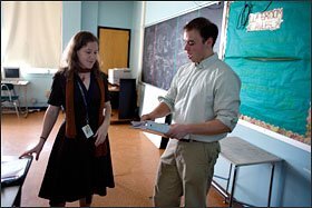 Cheyanne Zahrt, who teaches biology at the Academy of College and Career Exploration in Baltimore, confers with health teacher Todd Henning during an afterschool program at the 3-year-old small high school.