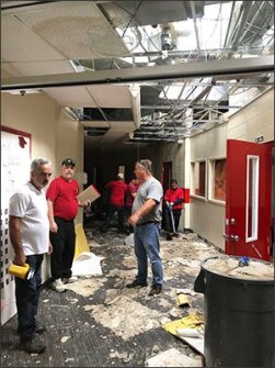Jaime Torrens, far left, the chief facilities officer for the Miami-Dade County school district, and Jim Norton, center, the superintendent of the Gulf County school district in Florida’s Panhandle, inspect Hurricane Michael's damage to Wewahitchka High School in Wewahitchka, Fla. Torrens and a colleague arrived seven days after the storm to help Norton and his team get schools ready to reopen.